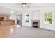 Open-concept living room features a fireplace and adjacent kitchen at 9905 Aftonwood St, Highlands Ranch, CO 80126