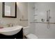 Bright bathroom with a sleek vanity, modern fixtures, and a accessible walk-in shower at 731 Uvalda St, Aurora, CO 80011