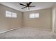 Bright bedroom with neutral walls, plush carpeting, and large windows providing plenty of natural light at 731 Uvalda St, Aurora, CO 80011