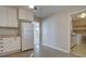 Kitchen with white cabinets, white refrigerator and laundry area at 731 Uvalda St, Aurora, CO 80011