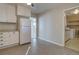 Kitchen with white cabinets, white refrigerator and laundry area at 731 Uvalda St, Aurora, CO 80011