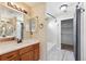 Updated bathroom featuring double vanity, modern fixtures, tile flooring, and tub/shower combination at 16351 E 104Th Pl, Commerce City, CO 80022