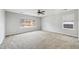 A spacious bedroom with neutral carpeting, base trim, and large windows at 16351 E 104Th Pl, Commerce City, CO 80022