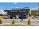 An exterior view of the Dutch Bros featuring blue accents and an appealing architectural design at 16351 E 104Th Pl, Commerce City, CO 80022