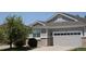 A well-maintained home with a grey exterior, brick accents, a two-car garage and a new roof at 16351 E 104Th Pl, Commerce City, CO 80022