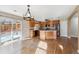 Bright kitchen with hardwood floors, center island, stainless steel appliances, and natural light at 16351 E 104Th Pl, Commerce City, CO 80022