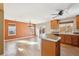 Open kitchen with hardwood floors, center island, stainless steel appliances, and natural light at 16351 E 104Th Pl, Commerce City, CO 80022