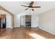 Bright living room with hardwood flooring, stone fireplace, and neutral paint at 16351 E 104Th Pl, Commerce City, CO 80022