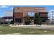 Modern restaurant featuring rustic steel accents, brickwork and an inviting outdoor patio at 16351 E 104Th Pl, Commerce City, CO 80022
