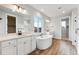 Luxurious bathroom featuring a soaking tub and double vanity at 1750 Marlowe W Cir, Erie, CO 80516