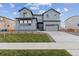 Two-story house with gray siding, landscaped lawn, and a two-car garage at 1750 Marlowe W Cir, Erie, CO 80516