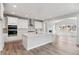 Spacious kitchen with white cabinets, island, and stainless steel appliances at 1750 Marlowe W Cir, Erie, CO 80516