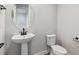 Small powder room with pedestal sink and toilet at 1750 Marlowe W Cir, Erie, CO 80516