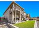 Exterior view showing a home's backyard with artificial turf, a patio, and stairs leading to a deck at 8829 Animas River St, Littleton, CO 80125