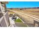 Backyard view with patio, fenced yard, manicured landscaping, and nearby walking path at 8829 Animas River St, Littleton, CO 80125