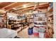 Organized basement with open ceiling, lots of storage, and shelving to optimize space at 8829 Animas River St, Littleton, CO 80125