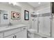 Bright bathroom features tiled shower with glass doors, modern vanity with granite countertop, and art at 8829 Animas River St, Littleton, CO 80125