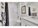 Bright full bathroom featuring a tub, shower combo, and modern white vanity at 8829 Animas River St, Littleton, CO 80125