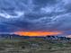 Scenic view of a neighborhood community with distant mountains and a colorful sunset sky at 8829 Animas River St, Littleton, CO 80125