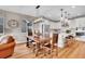 The dining area features a wooden table, chandelier, and is located near the modern, white kitchen at 8829 Animas River St, Littleton, CO 80125