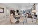 Open dining area featuring seating for six, seamlessly flowing into the living room at 8829 Animas River St, Littleton, CO 80125