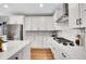 Modern white kitchen with stainless steel appliances, sleek countertops, and backsplash at 8829 Animas River St, Littleton, CO 80125