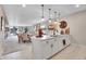 Well-appointed kitchen featuring a breakfast bar with seating and stylish pendant lighting at 8829 Animas River St, Littleton, CO 80125