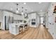 Bright kitchen featuring white cabinetry, stainless appliances and a modern island with seating at 8829 Animas River St, Littleton, CO 80125