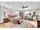 This spacious bedroom features a large bed, desk, ceiling fan, and neutral decor, creating a relaxing atmosphere at 8829 Animas River St, Littleton, CO 80125