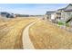 Scenic view of a paved walking path with a white fence and nearby homes at 8829 Animas River St, Littleton, CO 80125