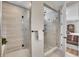 Modern shower room featuring glass walls, a shower head, and a view into the main bedroom at 8829 Animas River St, Littleton, CO 80125