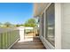 Outdoor deck with white railings overlooking a lush green lawn and trees under a clear blue sky at 6962 W 87Th Way # 270, Arvada, CO 80003