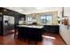 Modern kitchen with granite countertops, stainless steel appliances and wooden floors and island with bar stool seating at 6962 W 87Th Way # 270, Arvada, CO 80003