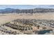 An extensive aerial view overlooking a neighborhood with mountain views under a picturesque blue sky with clouds at 9896 W Freiburg Dr # 1B, Littleton, CO 80127