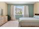 Calming bedroom featuring a light-blue accent wall and view of the outside hills at 9896 W Freiburg Dr # 1B, Littleton, CO 80127
