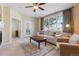 Comfortable living room featuring a ceiling fan, a large window, and neutral colors at 9896 W Freiburg Dr # 1B, Littleton, CO 80127