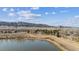 A serene pond surrounded by walking trails, natural open space, mature trees, and mountain views at 9896 W Freiburg Dr # 1B, Littleton, CO 80127