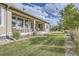 Lush backyard featuring a covered patio, manicured lawn, and mature trees, creating a private and peaceful outdoor retreat at 14883 Roslyn Way, Thornton, CO 80602