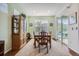 Bright dining room featuring a wooden table, display cabinet, and sliding glass doors to the backyard at 14883 Roslyn Way, Thornton, CO 80602