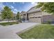 Lovely home with a spacious driveway, manicured lawn, and charming exterior featuring brick and siding accents at 14883 Roslyn Way, Thornton, CO 80602