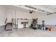 Spacious garage with ample storage, built-in cabinets, and organized shelving for tools and equipment at 14883 Roslyn Way, Thornton, CO 80602