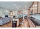 Open-concept kitchen featuring granite countertops, stainless steel appliances, and a breakfast bar seating at 14883 Roslyn Way, Thornton, CO 80602