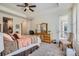 A well-lit main bedroom has neutral decor, a seating area and a glass door to the outside at 14883 Roslyn Way, Thornton, CO 80602