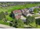 Aerial view of a two-story home with an attached garage, green lawn, and golf course views at 23427 Song Bird Hills Pl, Parker, CO 80138