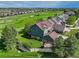 Aerial view of the green home featuring a well-manicured lawn, deck, and stunning golf course views at 23427 Song Bird Hills Pl, Parker, CO 80138