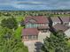 Aerial view of the green home featuring a well-manicured lawn, mature trees, and a spacious driveway at 23427 Song Bird Hills Pl, Parker, CO 80138