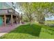 Spacious backyard featuring a lush lawn, mature trees, a tire swing, a fire pit and a deck with stairs at 23427 Song Bird Hills Pl, Parker, CO 80138