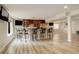 Modern bar area features seating, a bar counter, and a sink at 23427 Song Bird Hills Pl, Parker, CO 80138