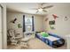 Playful bedroom with car bed, rocking chair, and fun dinosaur decor; a perfect ' room at 23427 Song Bird Hills Pl, Parker, CO 80138