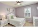 Charming bedroom with purple walls, white furniture, and a window with plantation shutters at 23427 Song Bird Hills Pl, Parker, CO 80138